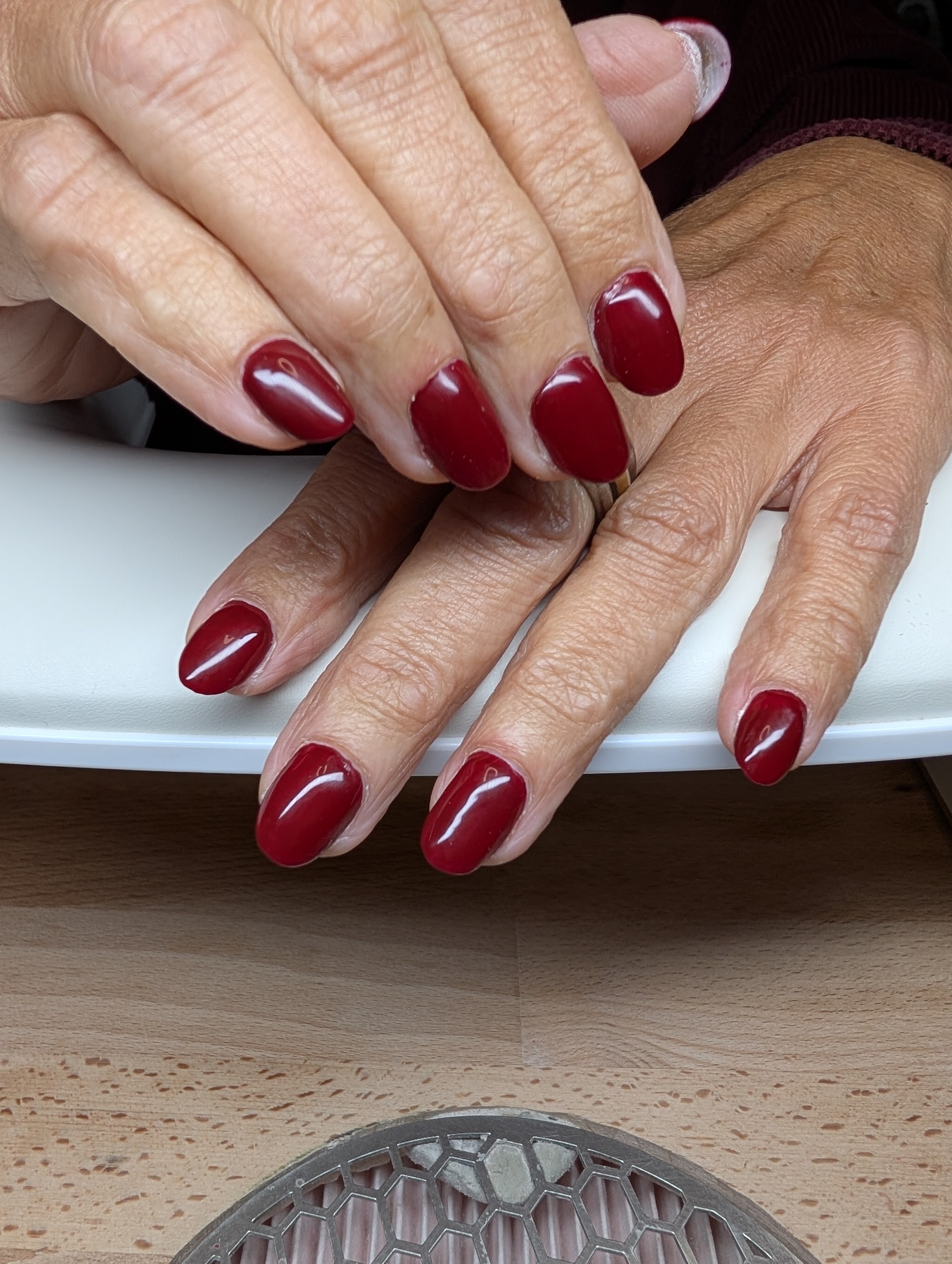 Dieprode nagels op een houten tafel